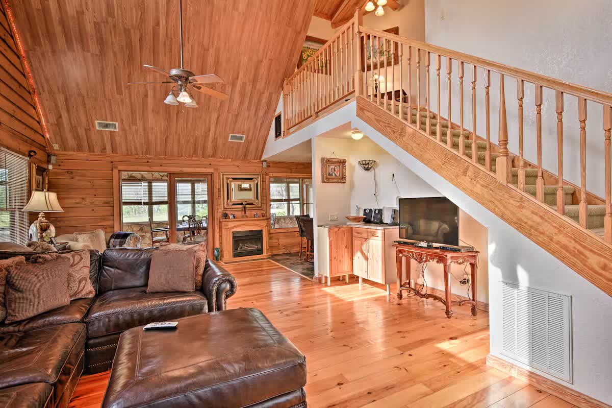 Knotted-pine living room with vaulted ceiling and fireplace